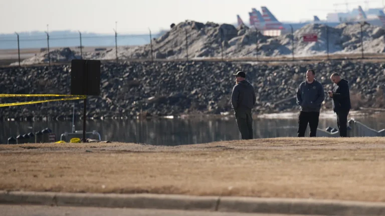 People look out towards the crash site of the American Airlines plane on the Potomac River as it approached the Reagan National Airport on January 30, 2025 in Arlington, Virginia. Andrew Harnik | Getty Images