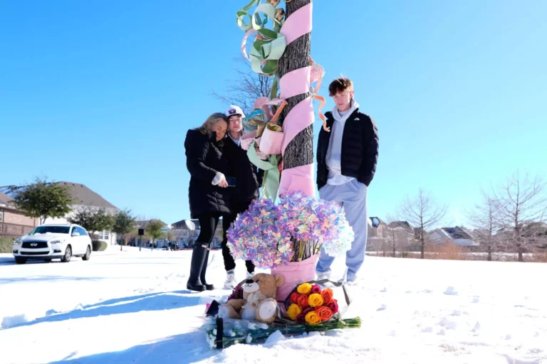 Debra Newby, left, and two others stand by a makeshift memorial, Monday, Jan 26, 2026, in Frisco, Texas, where over the weekend a 16-year-old female lost her life in a sledding accident that critically injured another. (AP Photo/Tony Gutierrez)