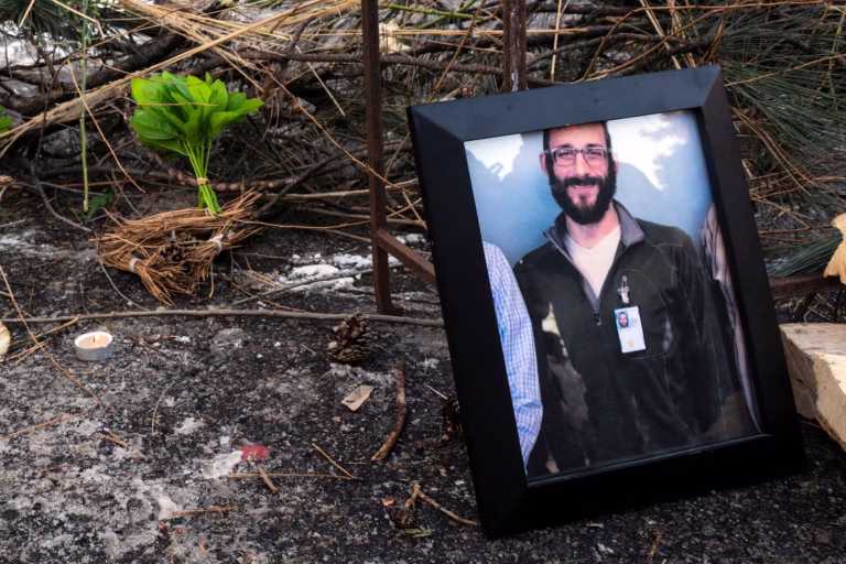A photograph of 37-year-old Alex Pretti can be seen at a makeshift memorial in the area where he was shot dead by federal immigration agents earlier in the day in Minneapolis, Minnesota, January 24, 2026. Roberto Schmidt/AFP via Getty Images